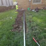 proper slope, cleanout access, and a pop-up drainage emitter t