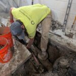 Digging for new pipe in floor